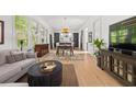 Bright living room boasts hardwood floors, large windows, and seamlessly connects to dining and kitchen areas at 262 Southerland Ne Ter, Atlanta, GA 30307