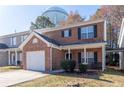 Red brick two-story home featuring a well maintained front yard and an attached one car garage at 538 Shadowmoore Dr, Riverdale, GA 30274