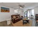 Cozy living room with a brown leather sofa, decorated with plants and a modern artwork at 575 Chapel Walk Ln, Lawrenceville, GA 30045