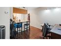 Kitchenette featuring granite countertop and two high chairs. Wood floor throughout at 795 Hammond Dr # 505, Atlanta, GA 30328