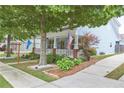 Beautiful home with a charming front porch, green lawn, and mature trees at 230 Ryan Ln, Covington, GA 30014