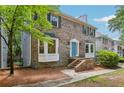 Beautiful two-story brick home featuring a charming blue door and lovely bay windows at 2356 Defoors Ferry Nw Rd, Atlanta, GA 30318