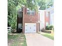 Cozy brick home showcasing an attached garage and proximity to neighboring houses at 2849 Windsor Forrest Ct, Atlanta, GA 30349