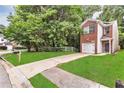 Charming brick home featuring an attached garage, driveway, and a well-manicured front lawn at 2849 Windsor Forrest Ct, Atlanta, GA 30349