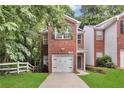 Charming brick home featuring an attached garage and a well-manicured front lawn at 2849 Windsor Forrest Ct, Atlanta, GA 30349