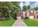 Charming brick home featuring an attached garage and a well-manicured front lawn at 2849 Windsor Forrest Ct, Atlanta, GA 30349