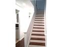 Elegant staircase with stained wood steps and white painted risers and railings at 2849 Windsor Forrest Ct, Atlanta, GA 30349