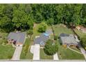 Aerial view of a suburban home with a backyard pool, fire pit, and lush greenery at 2920 Waverly Place Dr, Dacula, GA 30019