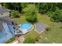 A backyard featuring an above ground pool, deck, and fire pit surrounded by a wooden fence at 2920 Waverly Place Dr, Dacula, GA 30019