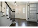 Elegant foyer with dark wood floors, staircase, and a clear view of the front door at 4493 Orleans Dr, Dunwoody, GA 30338
