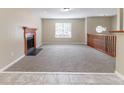 Open living space with plush carpeting, a charming fireplace, and views of the upper-level landing at 5339 Biffle Downs Rd, Stone Mountain, GA 30088