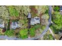 An aerial view showing the property, its landscaped yard, and neighboring homes at 6450 Oak Valley Dr, Cumming, GA 30040