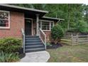 An inviting front entrance features stairs and sidewalk leading to a dark-colored front door at 1140 Allgood Rd, Stone Mountain, GA 30083