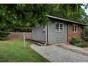 Side exterior view of home featuring gravel driveway and grey siding at 1140 Allgood Rd, Stone Mountain, GA 30083