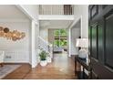 Inviting foyer with hardwood floors, a staircase, and views into the living areas at 2572 Hillgrove Dr, Dacula, GA 30019