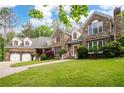 Beautiful stone home with a two-car garage, lush lawn, and professional landscaping at 355 Clark Creek Pass, Acworth, GA 30102
