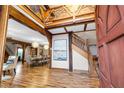 Grand foyer featuring hardwood floors, high ceilings, ornate wooden beams, and staircase at 355 Clark Creek Pass, Acworth, GA 30102