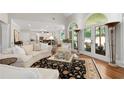 Spacious living room featuring a high ceiling, hardwood floors, and arched windows at 4390 Wicklow Ct, Suwanee, GA 30024