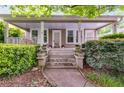 Covered front porch with swing, columns, plants, steps and walkway enhance this inviting home's appeal at 959 Hall Nw Pl, Atlanta, GA 30318