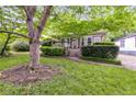 Inviting home with lush green lawn and mature shade tree in the front yard at 959 Hall Nw Pl, Atlanta, GA 30318