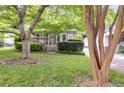 Exterior shot of a charming home with a lush front yard and mature tree at 959 Hall Nw Pl, Atlanta, GA 30318