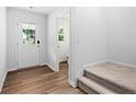Bright entryway features hardwood floors, a white door, and stairs leading to a cozy space at 132 2Nd Nw St, Atlanta, GA 30318