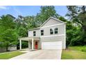 Charming two-story home featuring a covered front porch, two-car garage, and modern curb appeal at 132 2Nd Nw St, Atlanta, GA 30318
