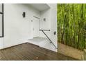 Exterior shot of a wooden deck leading up to a bright white doorway at 165 River North Walk, Atlanta, GA 30328