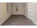 Neat room featuring new gray vinyl floors, a freshly painted interior, built-in shelves, and natural light at 1906 Oak Valley Rd, Decatur, GA 30035