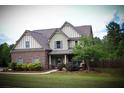 Inviting two-story home featuring a beautifully maintained lawn and covered front porch at 237 Arborview Dr, Mcdonough, GA 30252