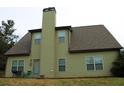 Back of house with green siding, view shows sliding glass door and a tall chimney at 237 Arborview Dr, Mcdonough, GA 30252