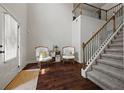 Inviting foyer with hardwood floors, staircase, and high ceilings creating an open and airy atmosphere at 237 Arborview Dr, Mcdonough, GA 30252