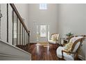 Grand foyer featuring hardwood floors, a staircase with an iron railing, and a two-story ceiling at 237 Arborview Dr, Mcdonough, GA 30252