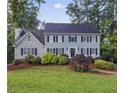 Traditional two-story home featuring a dark roof, light siding and well-manicured landscaping on a grassy lot at 4468 Windsor Oaks Dr, Marietta, GA 30066