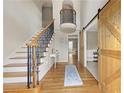 Grand foyer featuring a staircase, hardwood floors, barn door, and stylish decor at 4468 Windsor Oaks Dr, Marietta, GA 30066