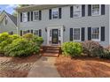 Inviting front entrance with a brick walkway leading to a classic front door and manicured bushes at 4468 Windsor Oaks Dr, Marietta, GA 30066