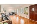 Spacious living room with hardwood floors, large windows, and a view into the dining area at 5478 Janice Ln, Stone Mountain, GA 30087