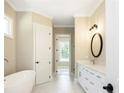 Well-lit bathroom with a soaking tub, modern vanity, elegant fixtures, and a neutral color palette at 1150 Sweet Mia Ln, Powder Springs, GA 30127