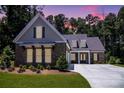 Beautifully landscaped single-Gathering home with a brick facade, two-car garage, and inviting double door entry at 1150 Sweet Mia Ln, Powder Springs, GA 30127