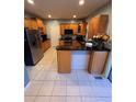 Well-equipped kitchen with tile floors, wooden cabinets, and stainless steel appliances at 1951 Bergerac Sw Ct, Marietta, GA 30008