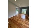 Open-concept living room features beautiful hardwood floors and natural light from large windows at 1951 Bergerac Sw Ct, Marietta, GA 30008