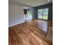 Bright living room showcasing gleaming hardwood floors and an open flow to the kitchen and deck at 1951 Bergerac Sw Ct, Marietta, GA 30008