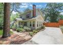 Charming home showcasing a long driveway, well-maintained lawn, and blooming garden beds at 47 Roseclair Se Dr, Atlanta, GA 30317