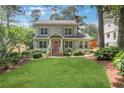 Charming home with green lawn and mature landscaping at 47 Roseclair Se Dr, Atlanta, GA 30317
