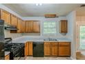 Well-lit kitchen features wooden cabinets, modern appliances, and a functional layout at 6185 Marbut Farms, Lithonia, GA 30058