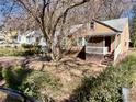Quaint tan home with covered porch amid a yard with mature trees at 1292 Lorenzo Sw Dr, Atlanta, GA 30310