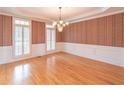 Formal dining room with hardwood floors, wainscoting, and a chandelier at 1900 Briergate Dr, Duluth, GA 30097