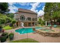 Resort-style backyard with private pool, hot tub, water slide, and large patio area at 280 Selkirk Ln, Johns Creek, GA 30097