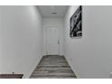 View of a bright hallway featuring wood floors and a stylish piece of wall art at 6125 Langdon Way, Cumming, GA 30028