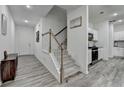 Open-concept kitchen featuring modern appliances, a stylish island, and easy access to stairs and hallway at 6125 Langdon Way, Cumming, GA 30028